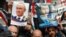 People hold posters of Russian President Vladimir Putin and Syrian President Bashar al-Assad during a rally in support of Russia's military invasion of Ukraine, in front of UN headquarters in Beirut in March 2022.