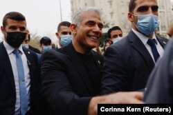 Jair Lapid, lider stranke Ješ Atid, smješka se na odlasku nakon glasanja na opštim izborima u Izraelu, na biračkom mjestu u Tel Avivu,23. marta 2021.