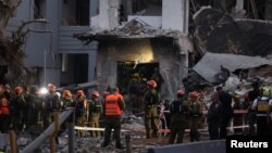 Иран зымыраны түскен жерде жүрген құтқару қызметінің адамдары. Тель-Авив, 16 маусым, 2025 жыл.