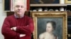 Russian art collector Aleksandr Khochinsky stands next to what Poland believes is the 18th-century painting Girl With A Dove.