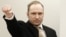 Norway -- Anders Behring Breivik raises his fist as he arrives to courtroom for the first day of his trial in Oslo, 16Apr2012