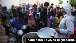 A man distributes free food during the holy fasting month of Ramadan in Jalalabad on May 7.