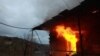 NAGORNO-KARABAKH - NOVEMBER 30, 2020: A house is set on fire in the town of Lachin (Berdzor). According to the trilateral agreement on a complete ceasefire signed by the leaders of Armenia, Russia, and Azerbaijan on 9 November, Armenia hands over Nagorno-