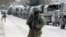 Armed servicemen wait in Russian army vehicles outside a Ukranian border guard post in the Crimean town of Balaclava March 1, 2014. 