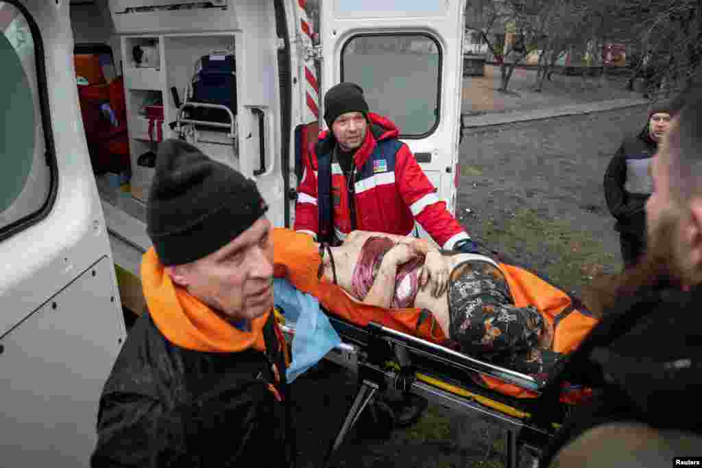 Medical workers treat a wounded resident.