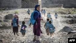 Children run to school in a village (file photo)