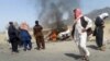 This photograph taken on May 21, 2016 shows Pakistani local residents gathering around a destroyed vehicle hit by a drone strike in which Taliban leader Mullah Akthar Mansur is believed to have been killed.