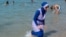 RELIGION-BURQA/FRANCE/A woman wearing a burkini walks in the water August 27, 2016 on a beach in Marseille, France, the day after the country's highest administrative court suspended a ban on full-body burkini swimsuits that has outraged Muslims and opene