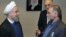 An undated photo issued by IRNA on December 1 shows Iranian President Hassan Rohani (left) awarding nuclear scientist Mohsen Fakhrizadeh a medal in Tehran.