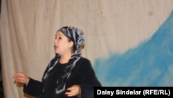 Aitadji Shabdanova, a state artist and performer with the Uzbek Music and Drama Theater in Osh, performs on stage.