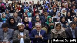 Afghan Chief Executive, Abdullah Abdullah (C) prays during an event marking International Women's Day, in Kabul on March 8
