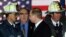 Russian President Vladimir Putin (center) with U.S. firefighters on November 15, 2001, as he visits the site of the September 11 terrorist attack that destroyed the twin towers of the World Trade Center in New York. 