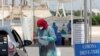 A health worker wearing a protective face mask takes someone's medical history at the drive-through screening and testing facility for coronavirus in Karachi on April 7. 