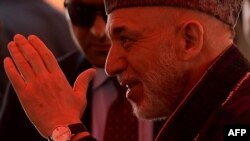 Afghan President Hamid Karzai at a charitable housing project event in Kabul on May 16