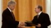 Russian President Vladimir Putin (right) and U.S. President Bill Clinton exchange agreements on the safe disposition of 68 metric tons of weapons-grade plutonium in Moscow on June 4, 2000.