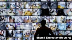 A man looks at a screen showing polling stations at the headquarters of Russia's Central Election Commission in Moscow on September 19.