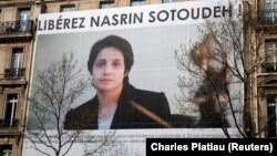 A banner with a giant portrait of jailed Iranian lawyer Nasrin Sotoudeh is seen on the headquarters of the French National Bar Council, which demanded her release, in Paris in March.