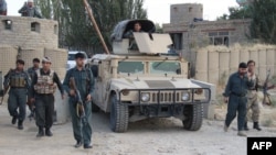 Afghan security personnel keep watch as heavy fighting erupted near the airport on the outskirts of Kunduz on September 29.