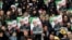 Mourners in Mashad hold placards depicting Qasem Soleimani on January 5