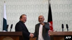 Pakistani Prime Minster Nawaz Sharif (L) shakes hands with Afghan President Ashraf Ghani during a press conference at the Presidential palace in Kabul on May 12.