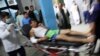 An injured man arrives at a hospital in Kabul following attacks at a sports center in a Shiite neighborhood of of Afghanistan's capital on September 5.