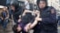 Riot police detain a man during an anticorruption protest on Tverskaya Street in Moscow. Protest organizer Aleksei Navalny has faced criticism for moving the demonstration to the Russian capital's central thoroughfare at short notice. 