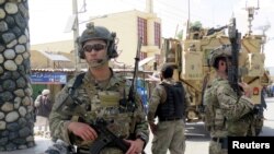 FILE: U.S. troops keep watch during an official visit in Farah Province.