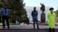 KYRGYZSTAN -- Police officers in face masks stand guard at the monument to Vladimir Lenin in the center of Bishkek, April 22, 2020