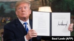 U.S. President Donald Trump signs a document reinstating sanctions against Iran after announcing the US withdrawal from a nuclear deal with Tehran on May 8.