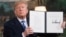 U.S. President Donald Trump signs a document reinstating sanctions against Iran after announcing the US withdrawal from a nuclear deal with Tehran on May 8.