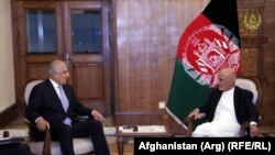Afghan President Ashraf Ghani (right) meets with U.S. envoy Zalmay Khalilzad in Kabul in July.