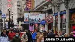Shoppers fill the streets around Piccadilly in central London on December 12, 2020.