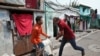 A plainclothes policeman wields his baton against a man as a punishment for breaking the lockdown rules, after India ordered a 21-day nationwide lockdown to limit the spreading of coronavirus disease (COVID-19), in Kolkata on March 25.