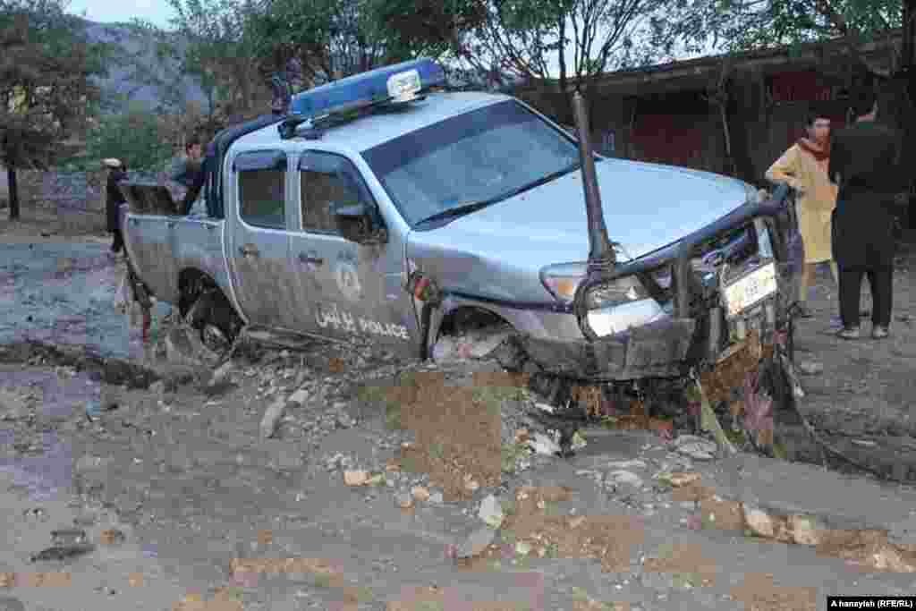 A damaged police vehicle was mired in the mud in Charikar.