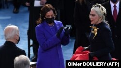 Lady Gaga is greeted by US President-elect Joe Biden and US Vice President-elect Kamala Harris during the inauguration on January 20, 2021.