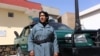 FILE: An Afghan female police officer stands guard outside a police station in Herat (October 2017).