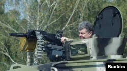 Ukrainian President Petro Poroshenko tries out a tank on July 26.