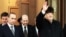 Outgoing Russian President Boris Yeltsin (right) waves as he hands over his office to Vladimir Putin (left) at Kremlin in Moscow on December 31, 1999.