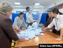 Officials sort ballots cast at a polling station Shymkent during the national referendum on nuclear power plants in October 2024.