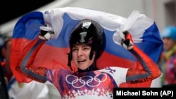 Skeleton racer Ylena Nikitina of Russia celebrates at the 2014 Sochi Olympics.