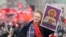 RUSSIA – Russian Communist party supporter carries a icon of Soviet dictator Joseph Stalin during the demonstration marking the Labor Day in Moscow, 01 May 2012